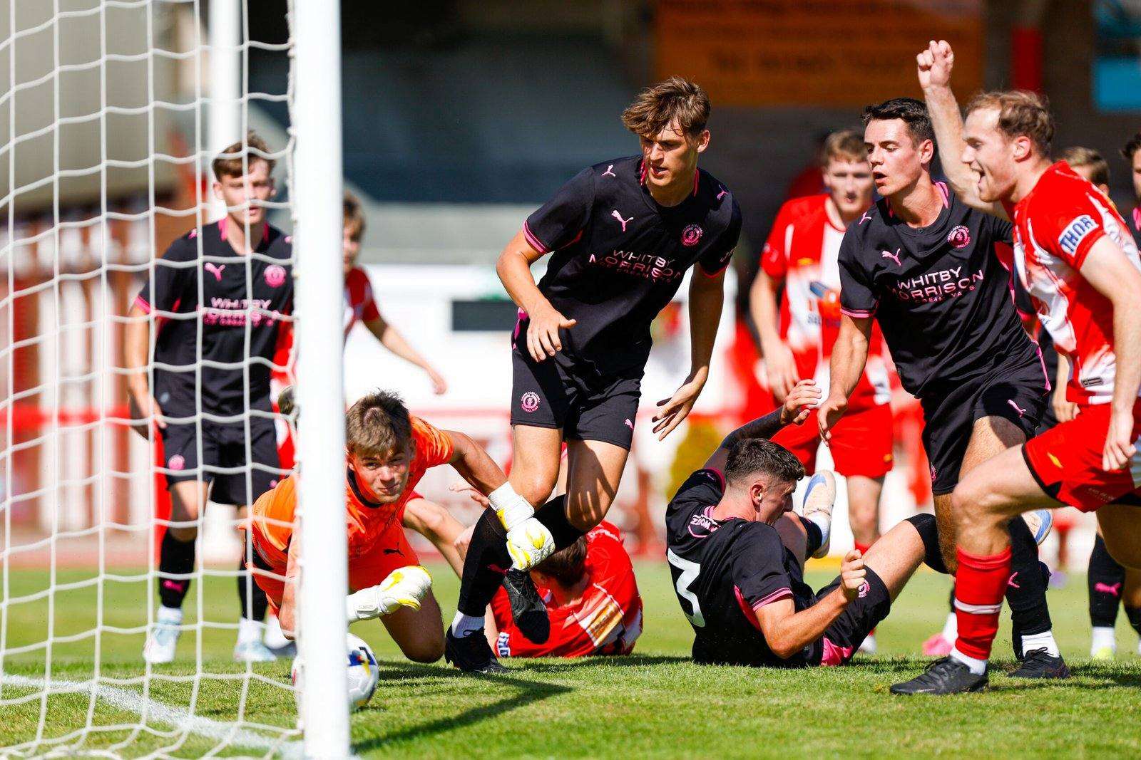 Witton Albion players together during a match